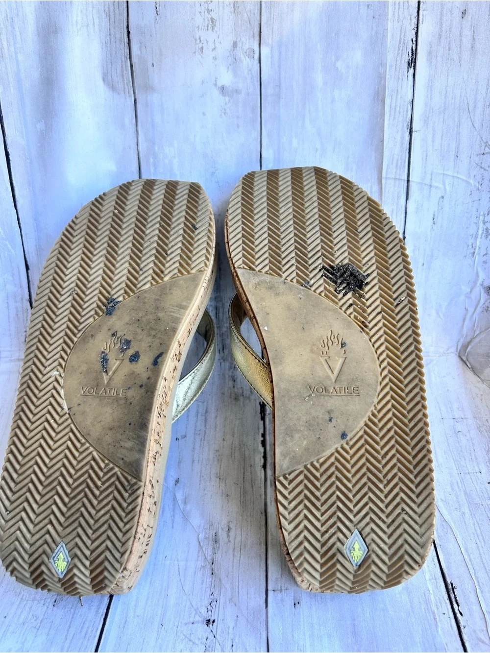 Volatile Gold thong wedge sandals with a cork platform,
